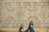 Distressed Serab runner with muted geometric medallions and stepped contours in ivory and brown.