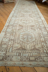 Distressed Persian Serab runner detail: geometric medallions, pawn border, pale blue and brown tones.