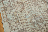 Reciprocating pawn design motif on distressed Serab runner in brown and pale blue.