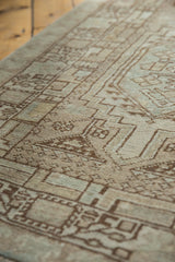 Distressed Serab runner's worn pile and geometric pawn motif in muted brown and ivory.