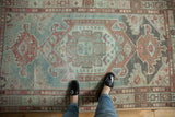 Oversized central medallion of the distressed Malayer rug, with a floral palette in muted blues and pale raspberry.