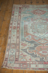 Distressed vintage Malayer rug corner, geometric borders, and worn field revealing foundation.