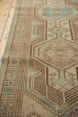 Distressed Serab runner with geometric patterns, detailed border, and visible textural wear.