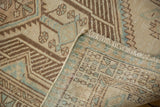 Distressed Serab runner corner with worn beige, brown, and blue pile showing hand-knotted reverse.
