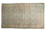 Distressed vintage Hamadan carpet with interconnected beige, powder blue, and brown medallions.