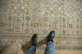 Distressed Persian Hamadan carpet with a low pile field of geometric medallions in beige and powder blue.