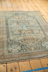 Distressed texture of the vintage Abadeh rug, revealing muted sky blue geometric patterns and low pile.