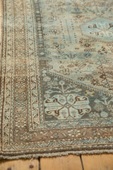 Vintage Abadeh rug corner: muted sky blue patterns, low pile, and visible knot heads.