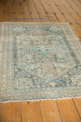 Vintage Distressed Abadeh Rug: muted blue, beige geometric patterns, ivory fringe.