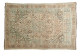 Distressed vintage Shiraz carpet, central diamond medallion, pale teal and ivory with brown geometric motifs.