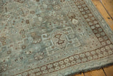 Texture of pale teal and brown geometric motifs, showing mostly even wear to knot heads.