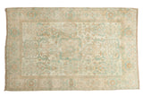 Distressed Sivas rug, neutral ivory and faded peach with sky blue floral geometric medallion.