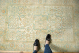 Distressed Sivas rug with neutral ground, faded blue, peach, and saffron floral motifs.