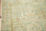 Distressed vintage Sivas rug, showcasing worn floral motifs in soft ivory, sky blue, and peach.