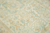 Faded ivory and sky blue floral geometric motifs on a vintage distressed Sivas rug.