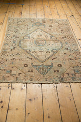 Distressed Hamadan rug showing lower geometric motifs, short fringe, and exposed knot heads.