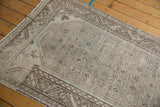 Distressed texture of a vintage Hamadan runner, highlighting muted heart motifs and patterned border.