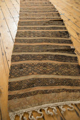 Braided fringe and contrasting dark brown, geometric banded patterns on this runner.