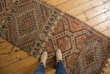 Intricate geometric diamond and stepped motifs on vintage Jijim runner in brown, orange, and ivory.