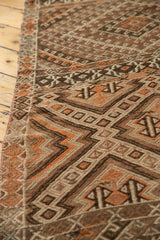Intricate hand-woven texture of the vintage Jijim runner with brown, tangerine, ivory patterns.