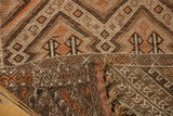 Folded vintage Jijim rug runner showing hand-woven geometric patterns and braided fringe.