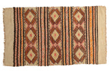 Vintage Jijim rug featuring banded geometric diamonds in ivory, brown, orange, and red.
