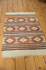 Jijim rug's simplistic plain ivory weave leading to horizontal banded patterns and fringe.