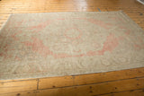 Distressed Vintage Oushak rug texture, showing even wear, dusty blush, ivory, and silver.