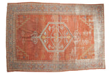 Distressed vintage Persian Mahal carpet, faded brick red, with bold geometric medallion, 6'5
