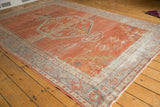 Distressed brick red field and traditional patterned borders on a vintage Mahal carpet.