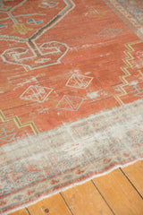 Distressed vintage Mahal carpet pile, brick red with exposed ivory foundation and geometric details.