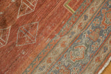 Textured distressed Mahal rug showing brick red field, geometric diamonds, and multi-toned borders.