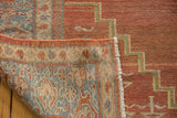 Distressed brick red Mahal rug pile, green geometric, and intricate hand-knotted reverse.