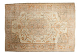 Distressed vintage Oushak carpet, expressive medallion in ivory, soft peach, and time-softened silver.