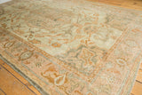 Distressed Oushak rug corner with even wear, foundation visible, ivory, peach, and gold motifs.