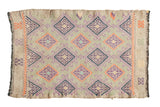 Embroidered Jijim rug mat, sea foam green with purple and tangerine diamond motifs.