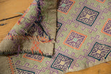 Hand-woven Jijim rug close-up showing vibrant geometric patterns and textured weave.