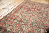 Antique Malayer runner's worn Herati pattern, geometric border, brick red, blush tones.