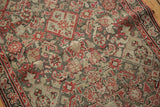 Close-up of the antique Malayer runner's abrash Herati pattern in brick red and silver tones.