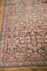 Antique Malayer runner detail: intricate border, Herati field, time-softened brick red, blush.