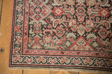 Antique Malayer runner corner shows brick red, blush Herati pattern with visible knot heads.