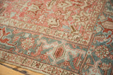 Distressed blush rose, antique ivory, and dusty blue geometric patterns on vintage Heriz pile.