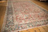 Distressed vintage Heriz carpet, allover geometric design, blush rose, ivory, and dusty blue tones.