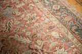 Distressed Persian Heriz carpet with geometric field in blush, ivory, and dusty blue.