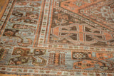 Detail of distressed Afshar rug pile, highlighting wear, chestnut rust, and pale powder blue motifs.