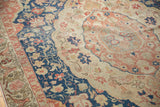 Distressed vintage Sivas rug, showing faded navy border, blush motifs, and worn knot heads.