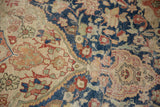 Distressed vintage Sivas carpet texture, highlighting navy blue, ivory, and blush patterns.