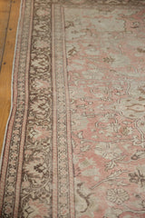 Distressed Oushak rug border with pale blush, chocolate, ivory floral design, and soft texture.