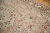 Distressed Oushak carpet's field revealing pale blush and antique ivory curvilinear motifs.