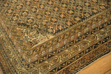 Intricate geometric borders with sky blue accents and starburst motif on antique Caucasian carpet.